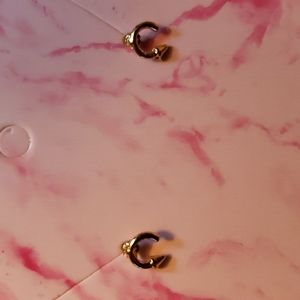 Small gold curved arrow earrings